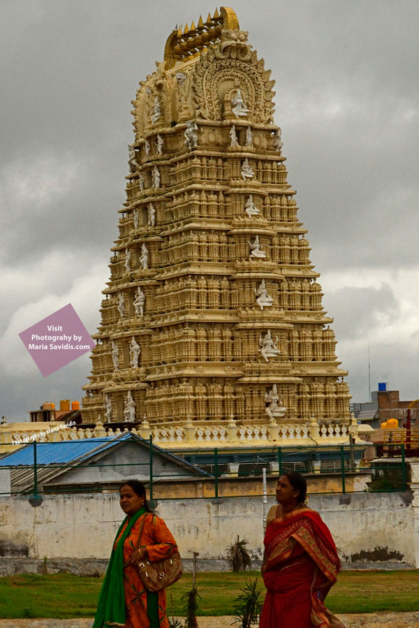 Two women walking past the Shri Chamundeshwari Temple