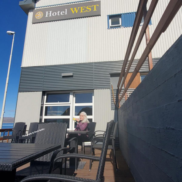 Sitting outside of the hotel breakfast room enjoying some sun and tea.