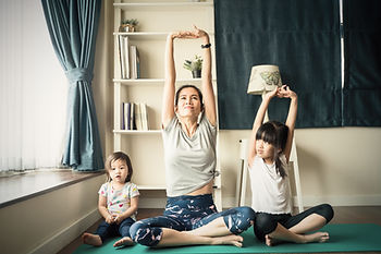 Asian mother and children doing yoga.