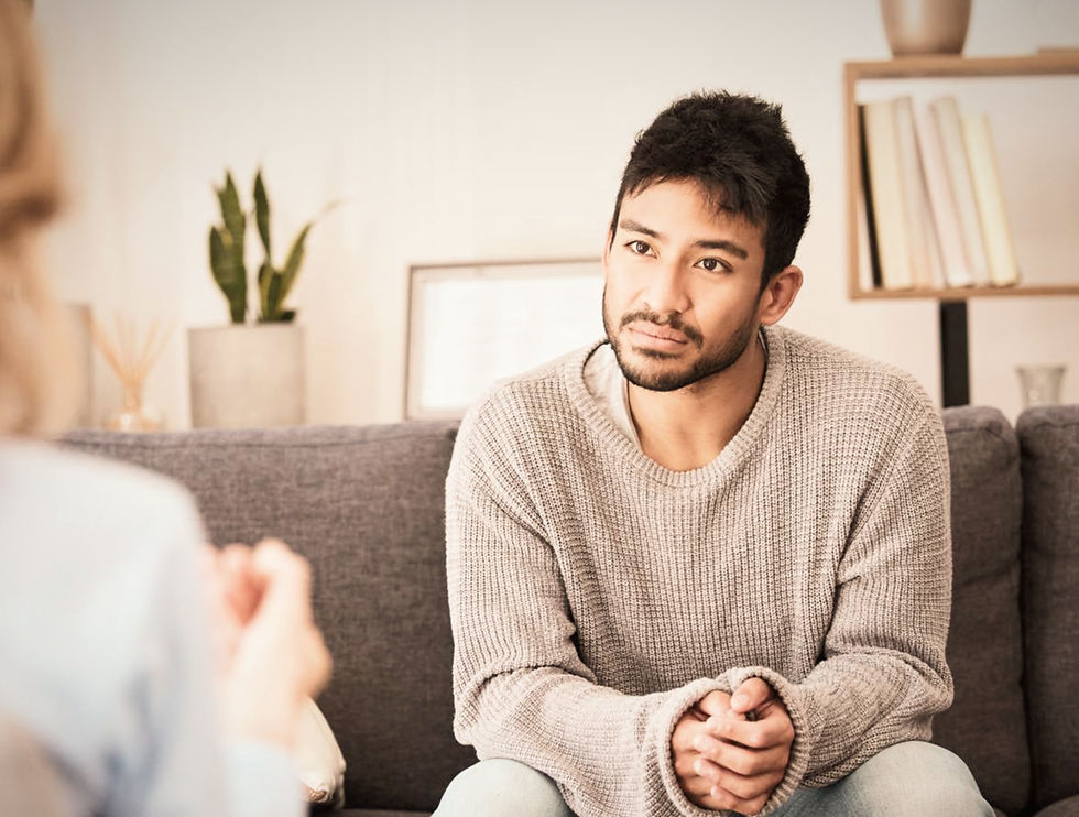 Latino man sitting across from a therapist