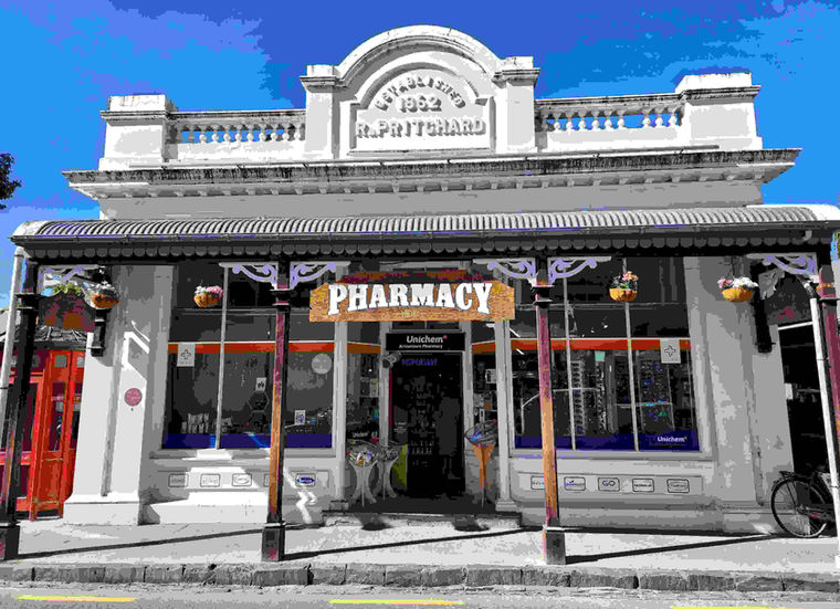 R. Pritchard Pharmacy: The ornate 1862 facade of the R. Pritchard building in Arrowtown, currently housing a pharmacy, highlighting preserved 19th-century commercial architecture.