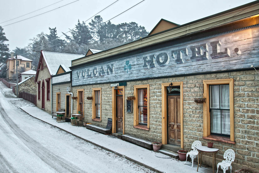 Vulcan Hotel, St Bathans: The iconic stone facade of the Vulcan Hotel in St Bathans, Otago, showing 19th-century gold rush era architecture on a light snowy morning.