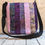 Thumbnail: Large Messenger Bag - back view - Purple Dreams print, 100% Cotton, Color: Batik Purples/Lavender/Green, Special Features: Strip pieced, magnetic closure, 5 pockets, cotton webbing strap, color coordinated zippers, size: Size: 13" W x 14"L, JordynCherise 