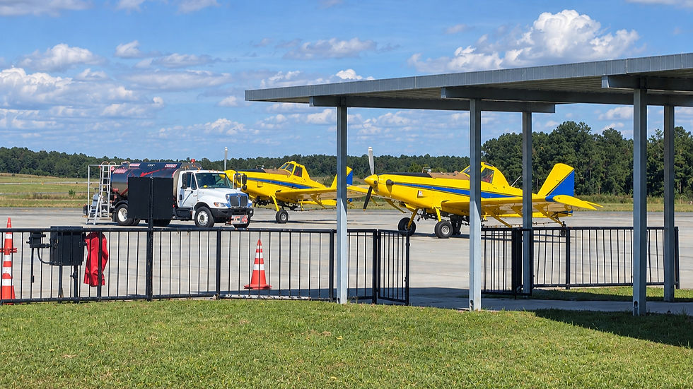 Yellow planes and fuel truck on FBO tarmac