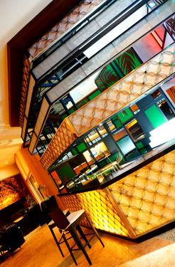 Boutique hotel design by B&Ö showing a premium lobby lounge and hotel bar with layered lighting and durable finishes.