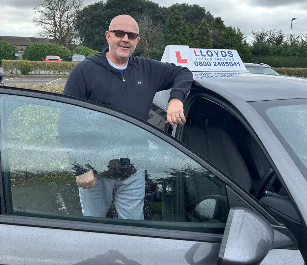 Keith stood alongside his driving school car