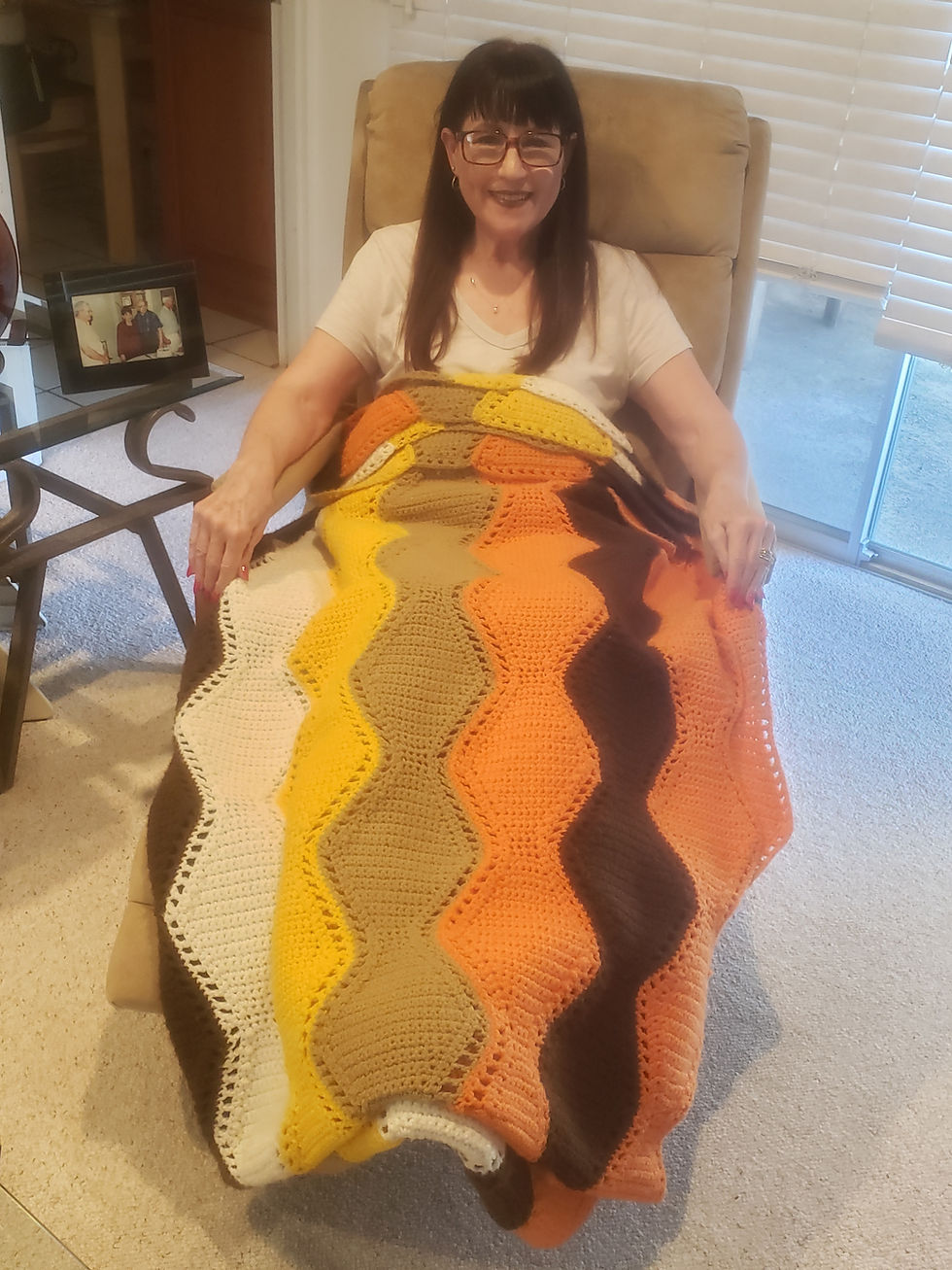 Alise with her Mom's afghan created in the 1960's