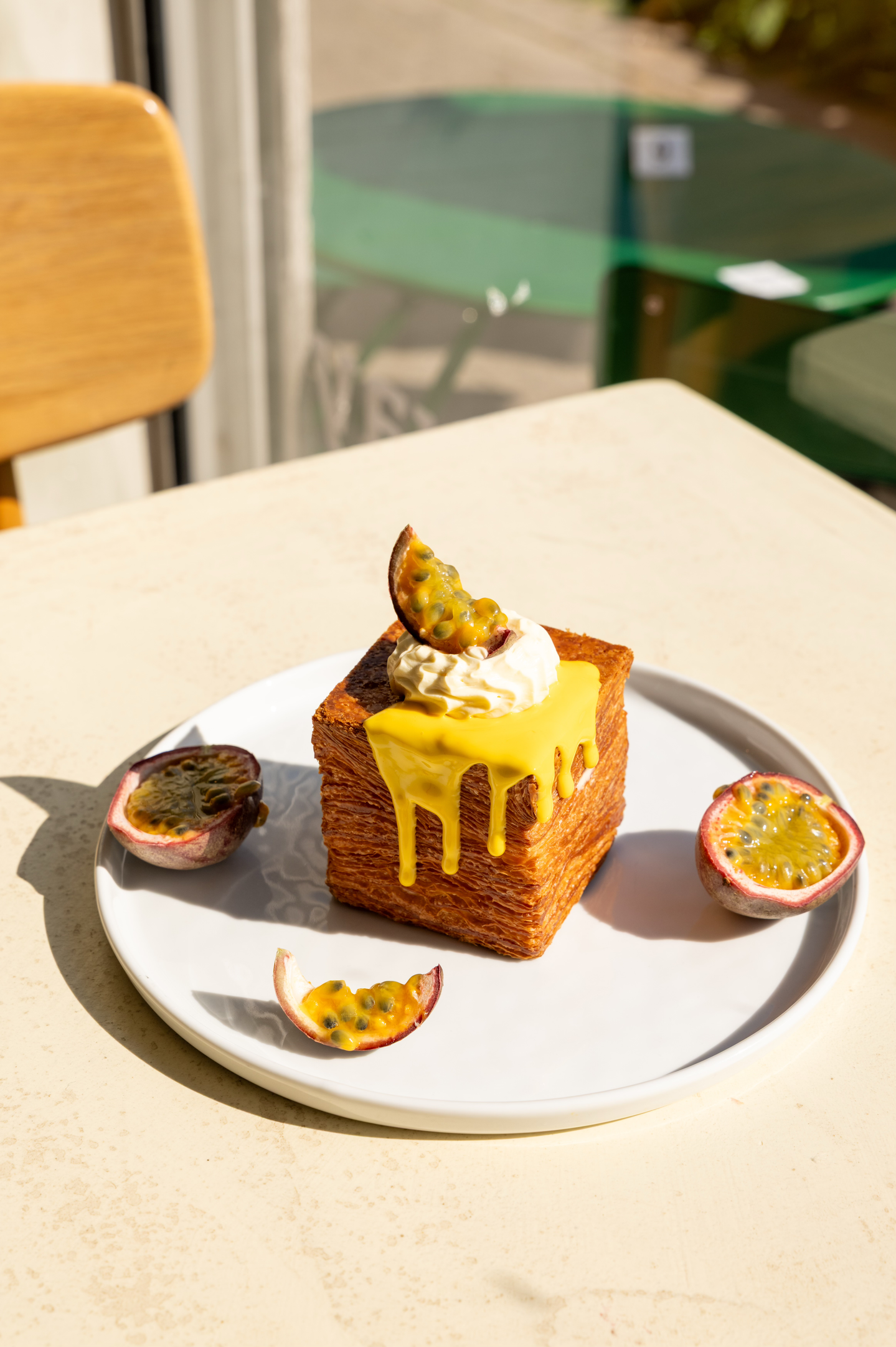 Pastry with yellow topping and passion fruit garnish.