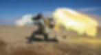 Soldier kneels on desert ground firing a rocket launcher, bright flames burst from weapon. Clear blue sky, military vehicle in background.
