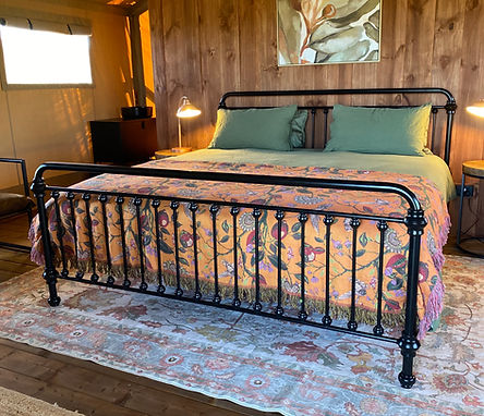 The Sea Rise tent interior showcases elegant furnishings and cozy comforts, creating a luxurious glamping retreat.