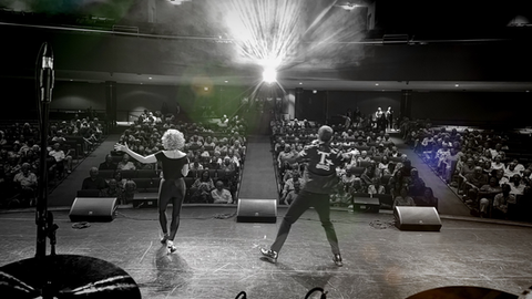 Black and white photo from the stage of everyone at The Olivia Show, starring Sabrina Plaisance.