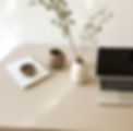 vecteezy_ai-generated-desk-with-laptop-vase-and-lamp-on-white-table_35795600.jpg