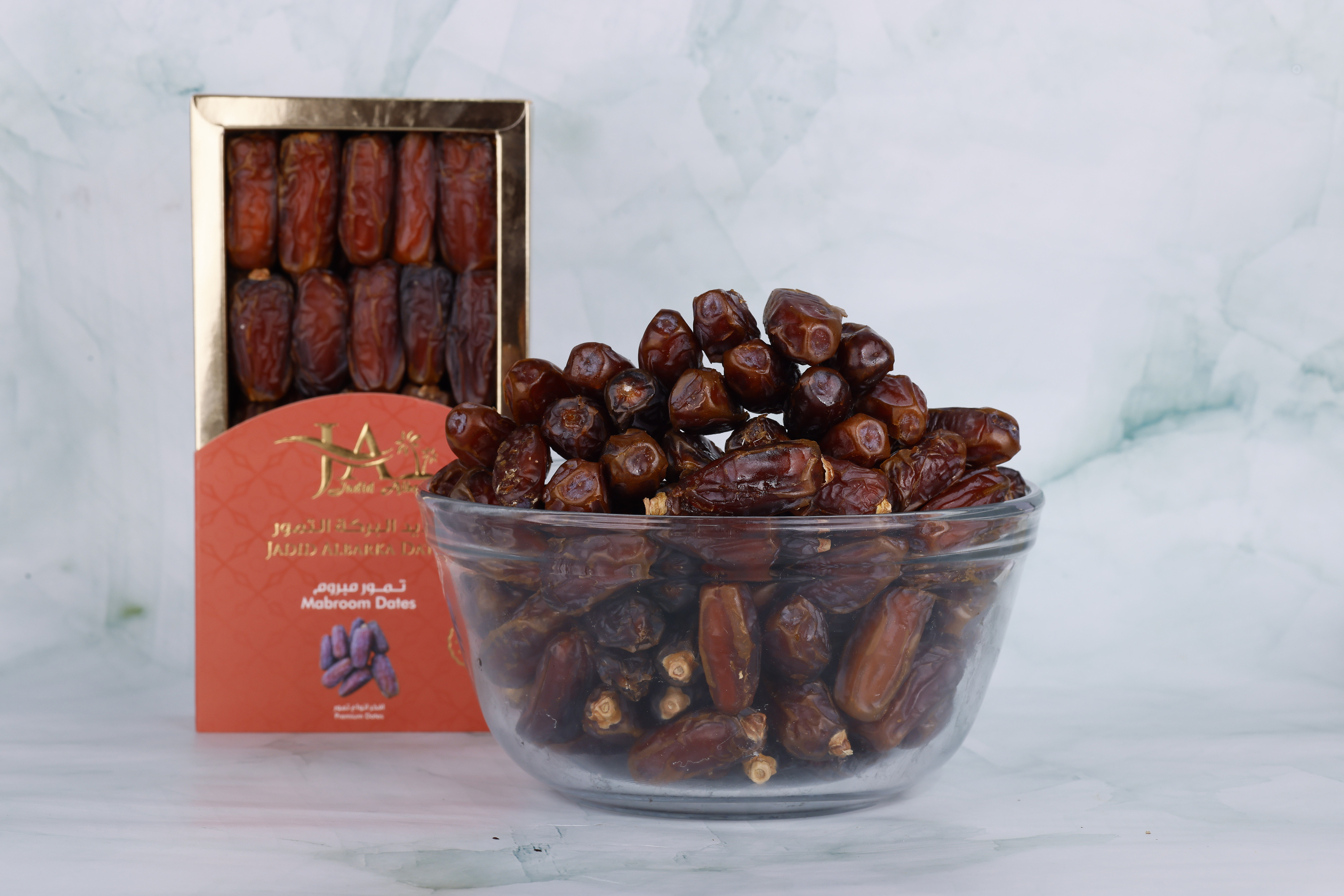Premium Ajwa dates in a glass bowl and box