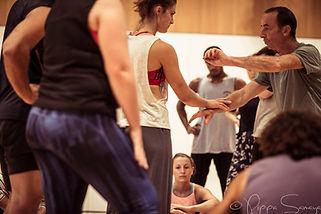 Adam teaching students looking on