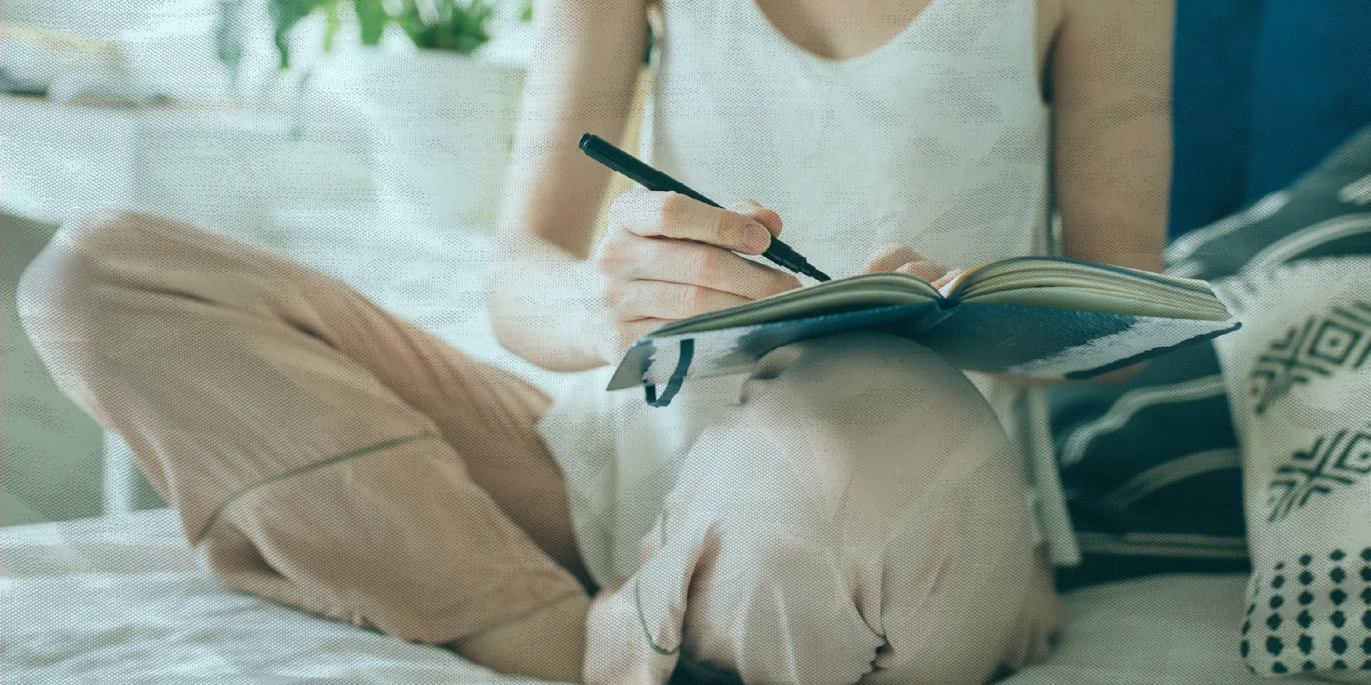 What To Do This Weekend | Health SZN | A woman practicing gratitude journaling while sitting on a bed in trendy clothes
