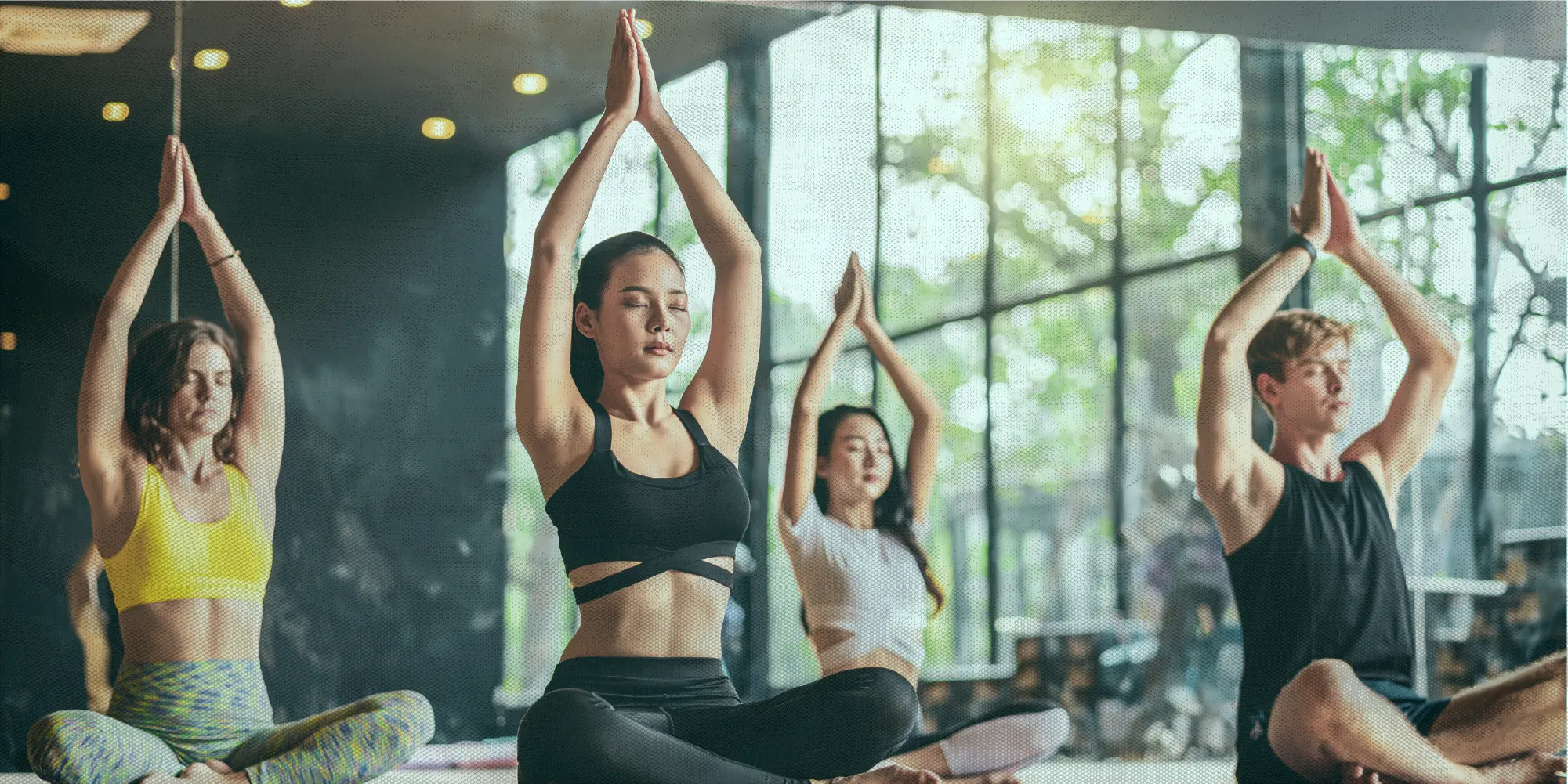What To Do This Weekend | Health SZN | A diverse group of people practising group meditation in a beautiful yoga studio being led by an asian instructor with well defined abs