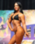 Female bodybuilder poses in black bikini at Red River Classic