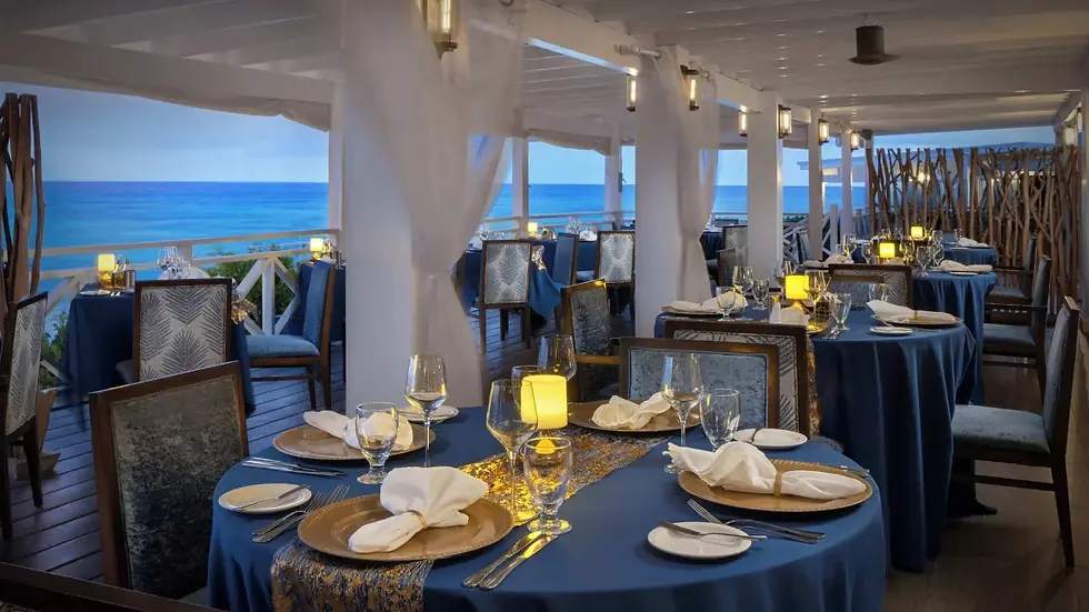 Eye-level view of a beachfront resort pool area decorated with lights and palm trees for New Year's Eve