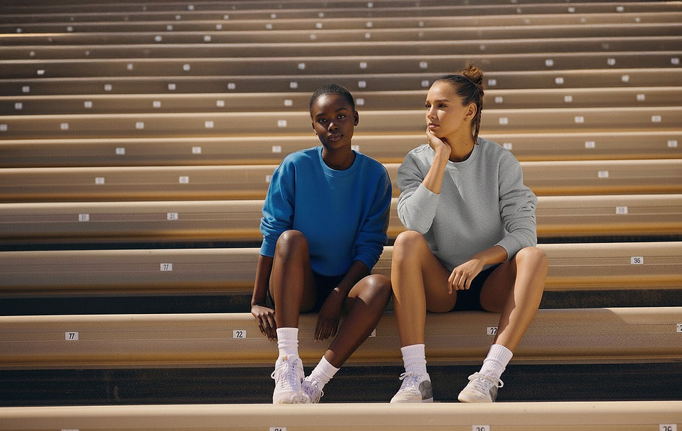 ered stadium bleachers, wearing sweatshirts, shorts, and sneakers, looking in different directions.