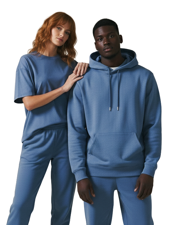 A couple wearing blue sweatshirts and pants stands together, exuding a friendly and casual vibe.