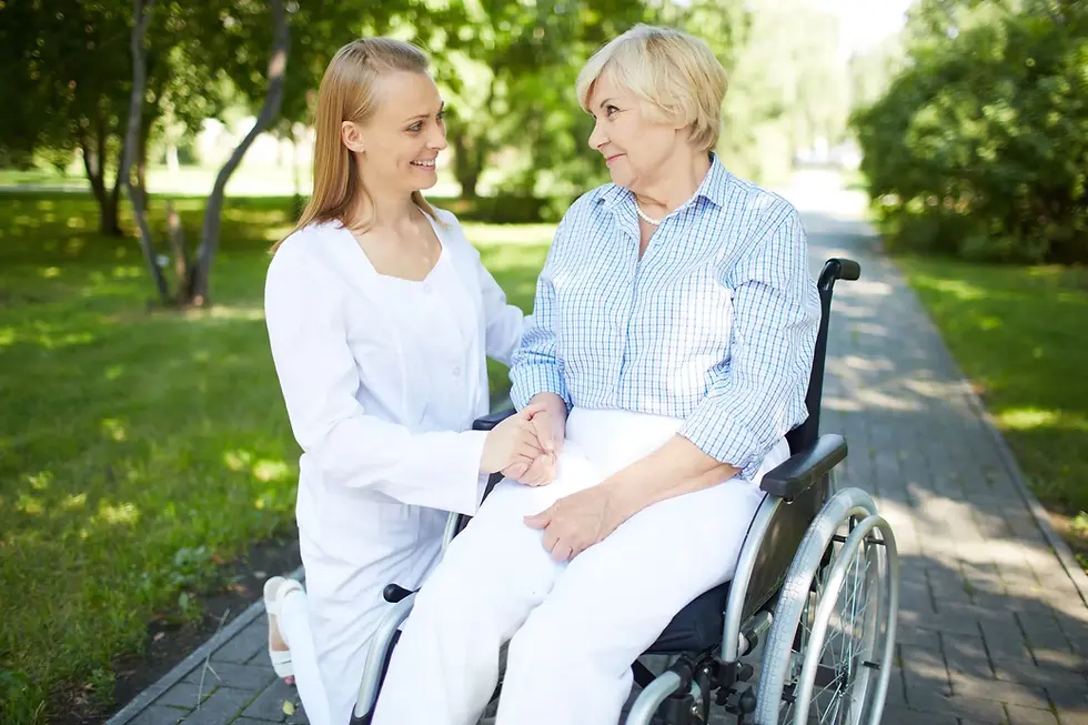 A person on a walk with their elderly relative in a wheelchair