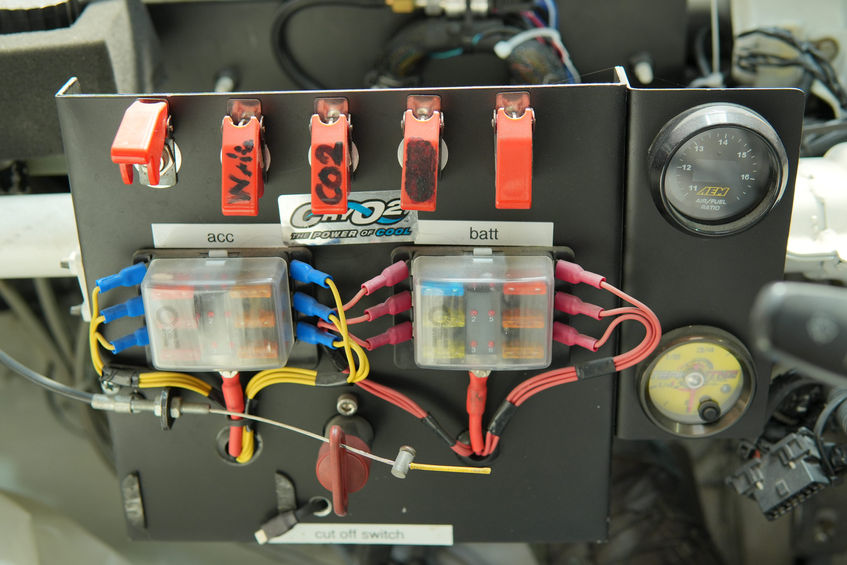 Electrical control panel with switches, fuses, and gauges