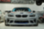 Gray custom race car in a performance shop.