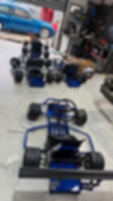Blue go-kart frames in a garage