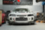 White race car in a Special Performance workshop