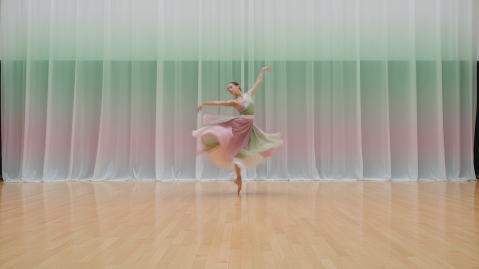 Close-up view of a polished wooden dance floor in a spacious studio
