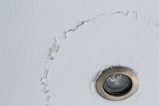 popcorn ceiling damage around light.jpeg