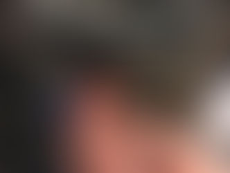 A mechanic inspecting the drivetrain of an assistive handcycle (Batec, by the looks of it).