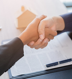 Real estate broker agent Shake hands after customer signing contract document for ownershi
