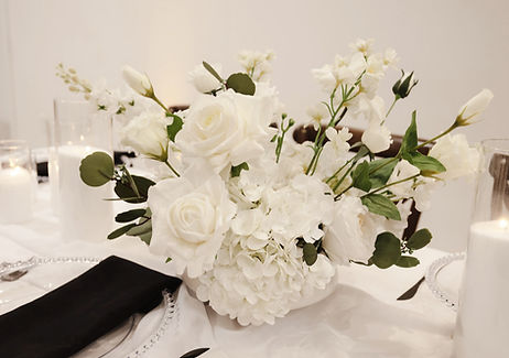 White wedding flower centerpiece with roses and hydrangeas for a Williamsburg celebration