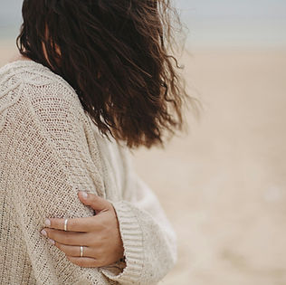 woman in white sweater holding black round frame_edited.jpg