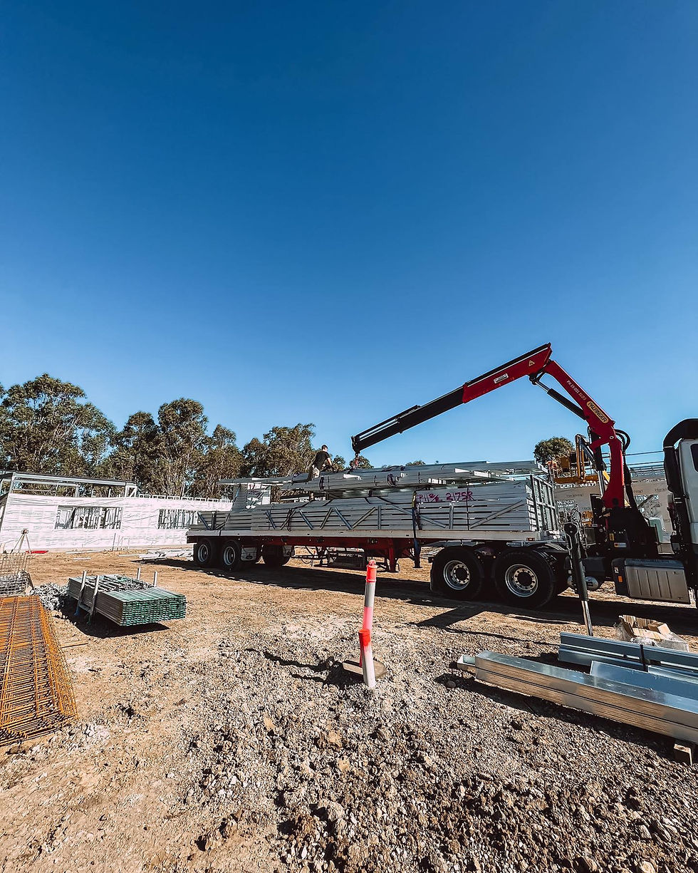 Reliable steel framing for owner builders delivered by crane truck.