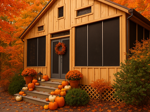 Autumn-themed porch with pumpkins, potted flowers, and a wreath. A wooden house is surrounded by vibrant orange foliage, creating a cozy mood. Home window and doors feature security window screens.