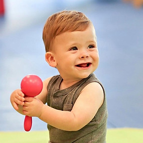 Baby play classes baby playing with musical instrument