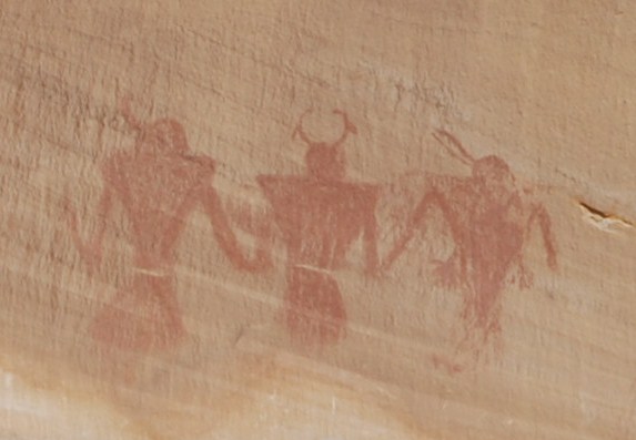 forms painted in red on cliffside
