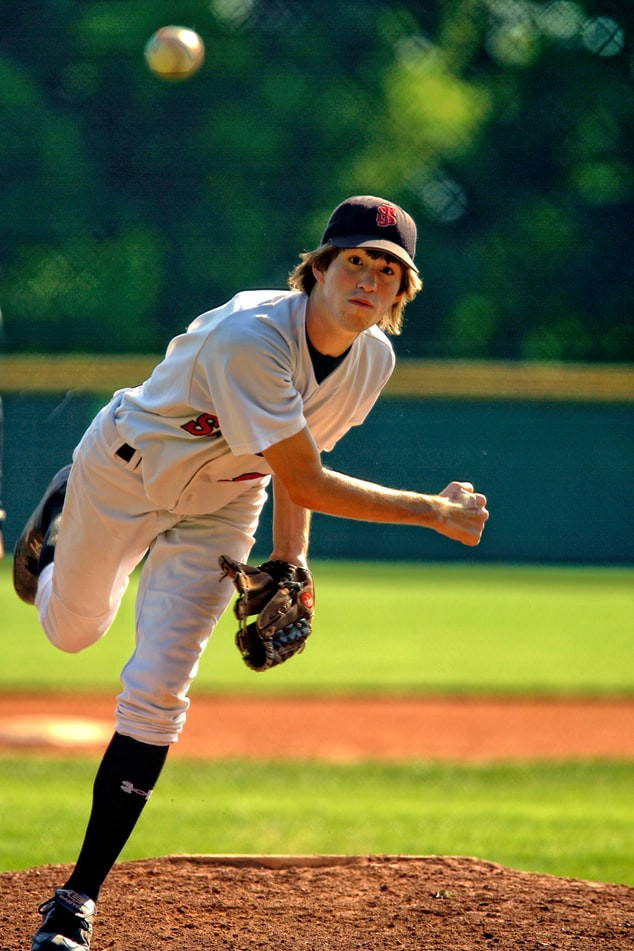 baseball player practising his pitch