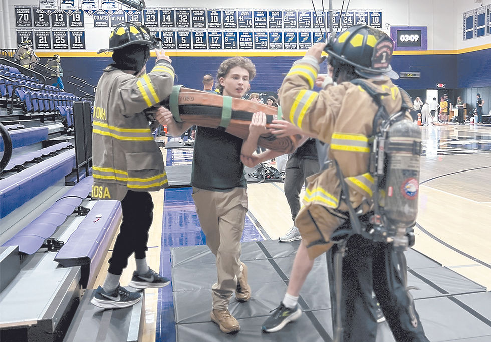 Students simulate training drills as part of the two-day "Trial by Fire" program led by volunteers from four fire companies.