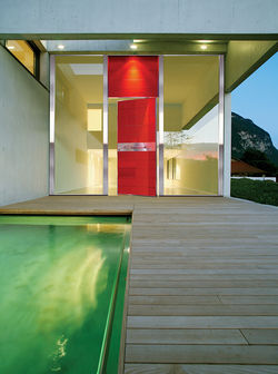 Pivot Door covered with glass insets and upper steady part made of the same material