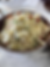 Bowl of colorful fried rice with vegetables on a speckled countertop. Fork resting inside, creating a fresh and appetizing mood.