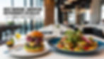 Gourmet burger and salad in a modern restaurant with city view. Text: Best Modern American Restaurants in Dallas - Must-Visit Spots.