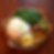 A traditional thali with rice, leafy curry, legumes, soup, sliced fruit, red chilies, and herbs on a wooden table, exuding a vibrant and inviting feel.