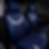 Luxury car interior with two sleek, dark blue leather seats featuring white accents. Modern design, no visible text, elegant mood.