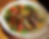 A vibrant salad with grilled steak strips, sautéed peppers, onions, and greens. Garnished with cilantro and served on a white plate.