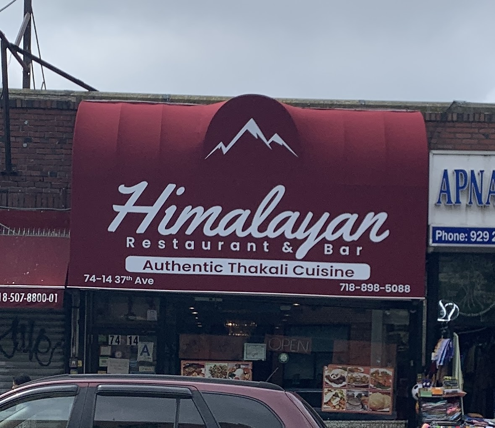 Red awning of Himalayan Restaurant & Bar with white text: "Authentic Thakali Cuisine." Street view, partly cloudy sky, parked car.