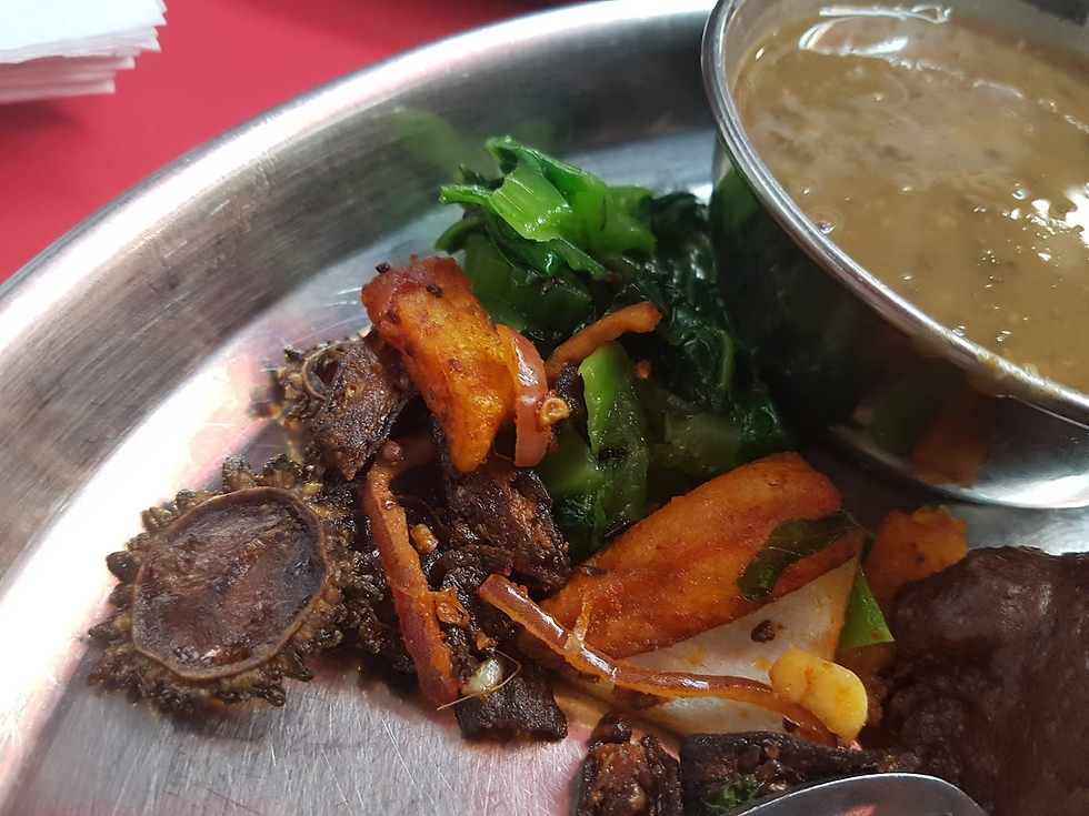 Plate with grilled meat, carrots, greens, and a dish of lentils on a metal tray. Red background, vibrant colors, appetizing scene.