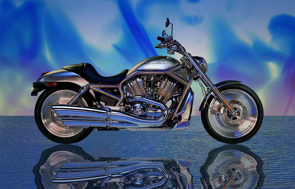 Harley-Davidson V-Rod motorcycle photographed in a studio with dramatic lighting, chrome detailing, and a reflective floor.